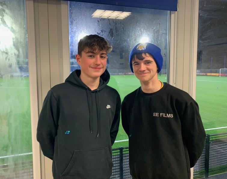 Ethan Ellis (right) with pal Ben Lovell take shelter from the rain at the Bridge Meadow Stadium